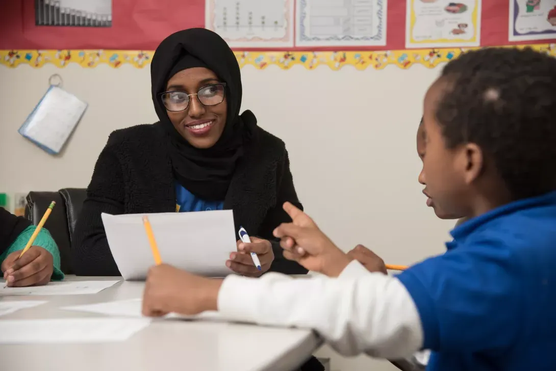 Student teacher working in classroom with students